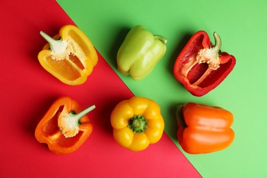 Flat lay composition with ripe bell peppers on color background