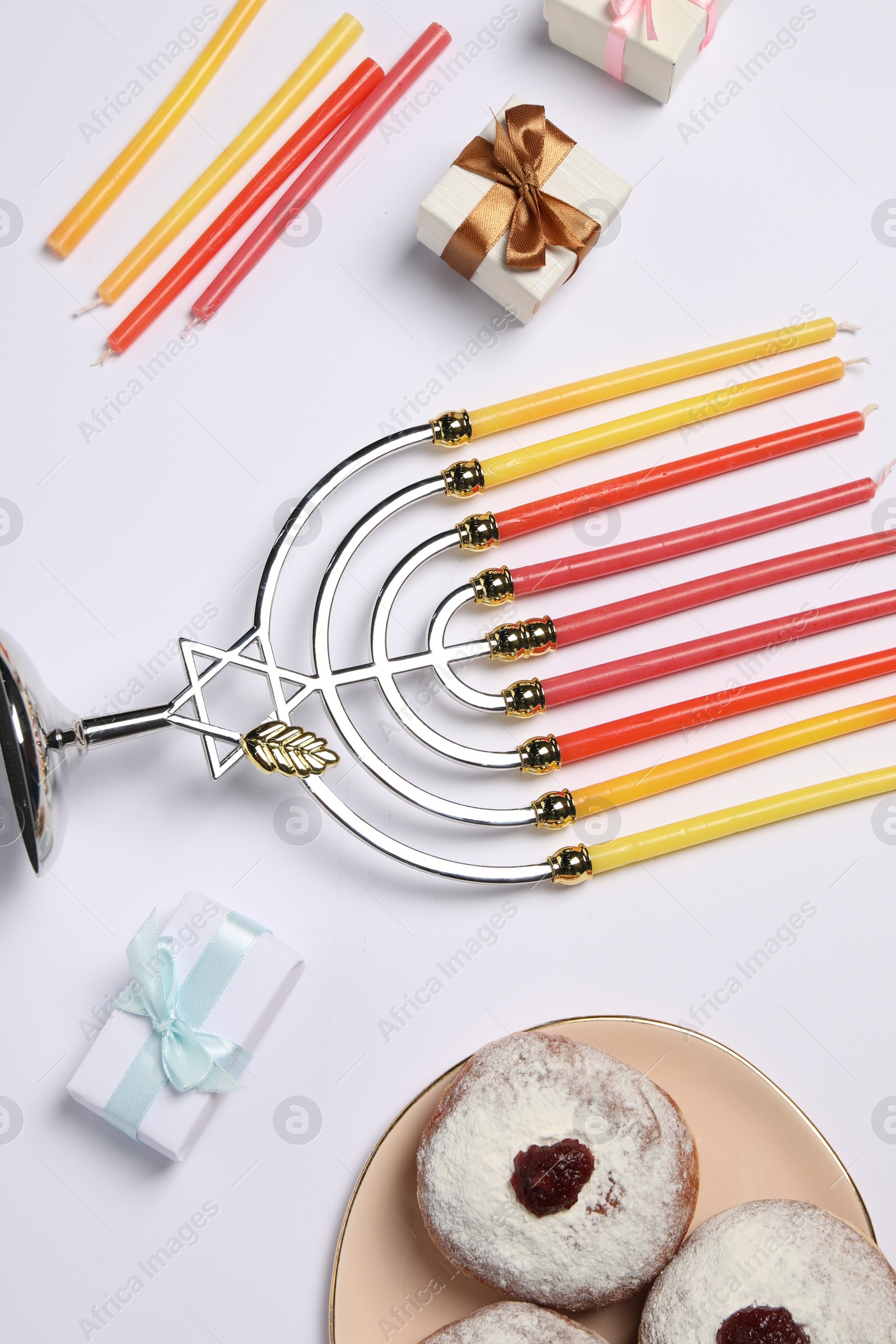 Photo of Flat lay composition with Hanukkah menorah and donuts on white background