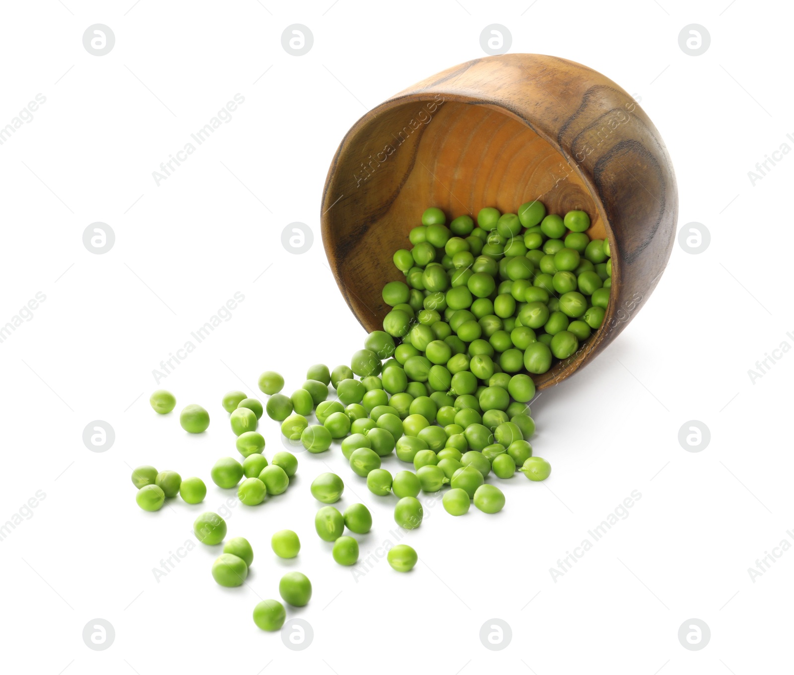Photo of Overturned wooden bowl with fresh raw green peas on white background