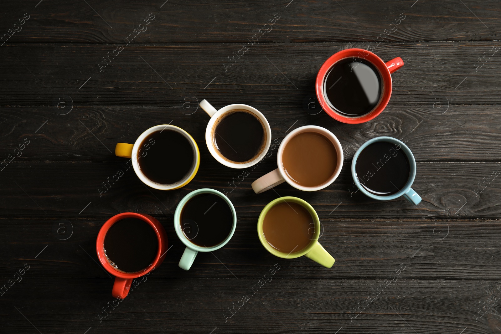 Photo of Flat lay composition with cups of coffee on wooden background. Food photography