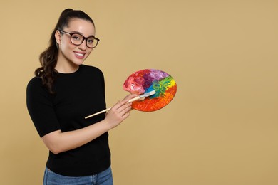 Photo of Woman with painting tools on beige background, space for text. Young artist
