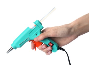 Woman holding turquoise glue gun with stick on white background, closeup
