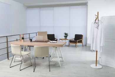 Photo of Modern medical office interior with doctor's workplace