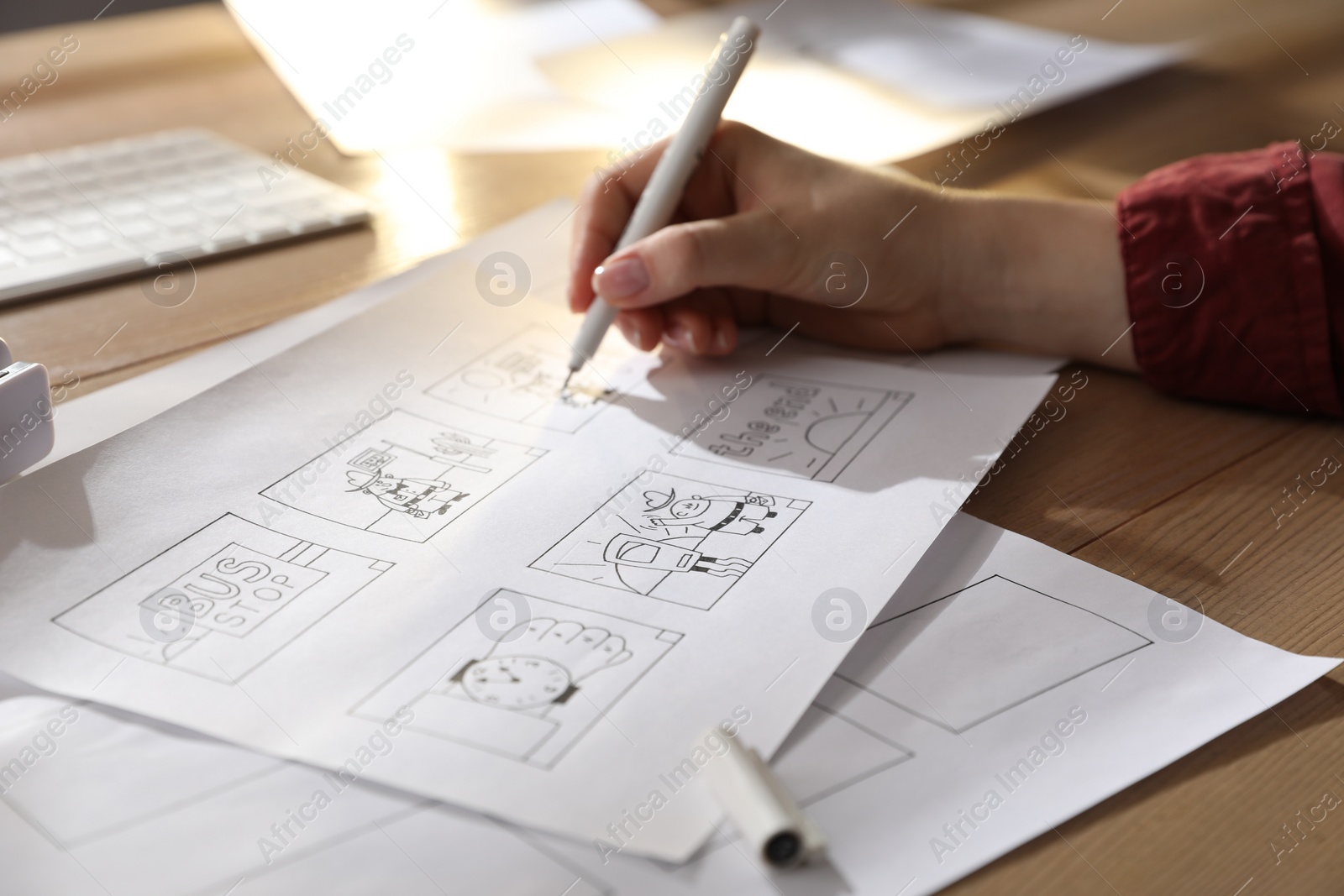 Photo of Woman drawing cartoon sketches at workplace, closeup. Pre-production process