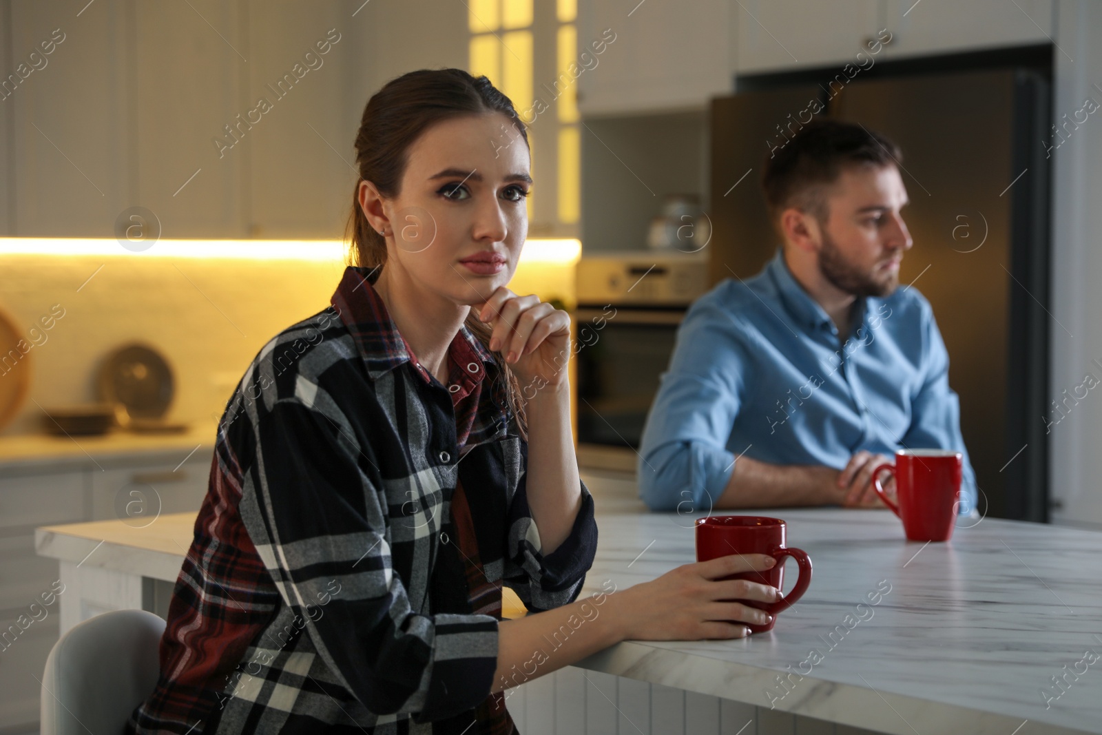 Photo of Young couple quarreling at home. Jealousy in relationship