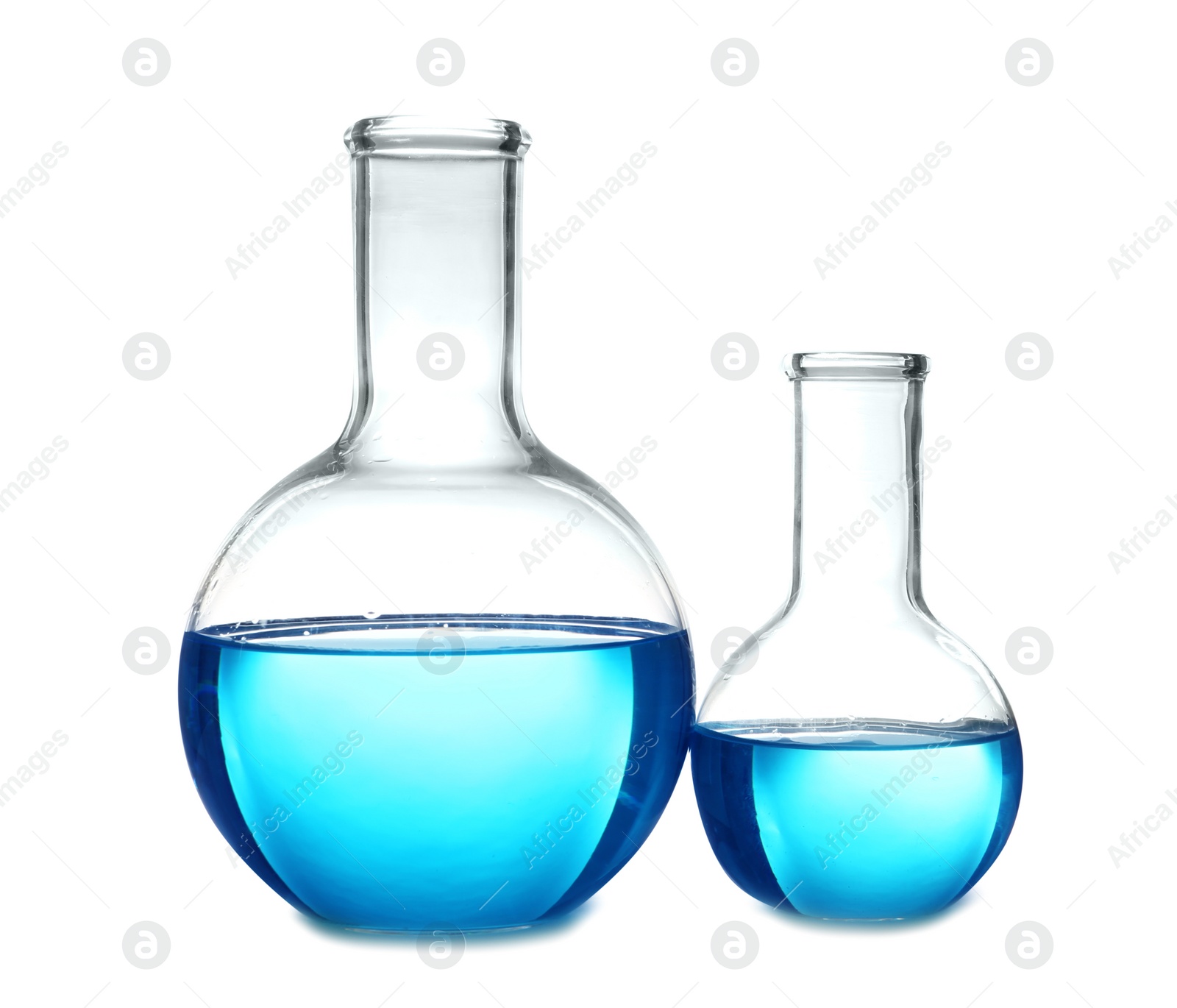 Photo of Flasks with blue liquid on table against white background. Laboratory analysis