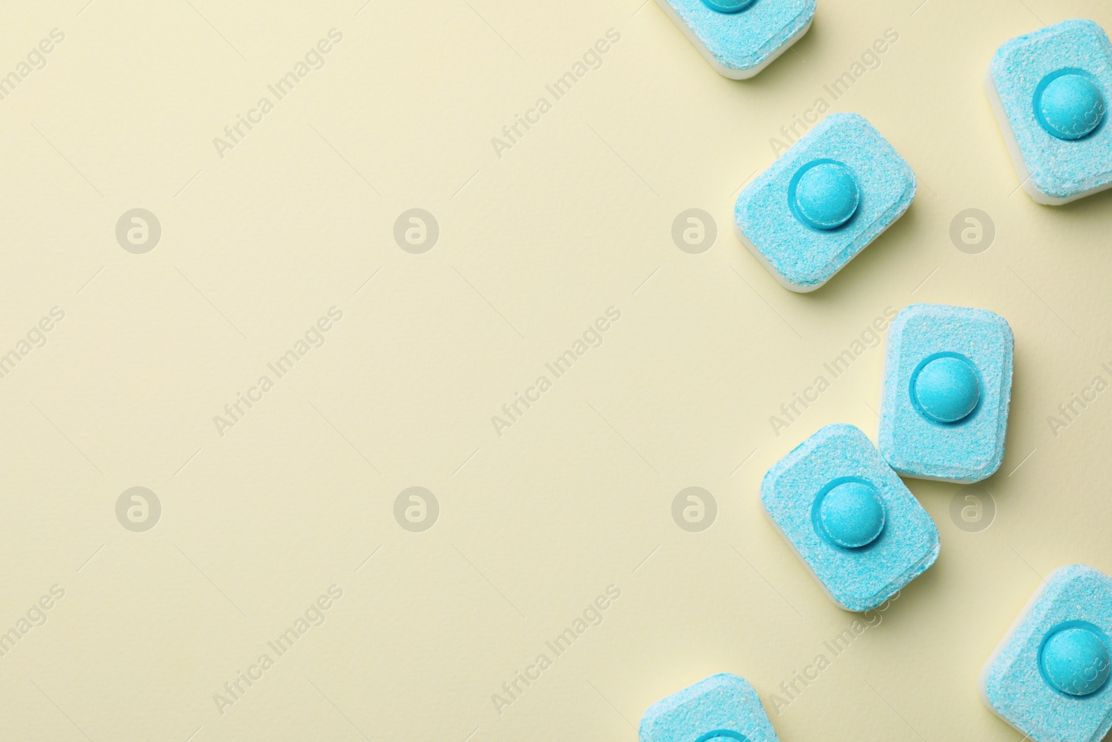 Photo of Water softener tablets on beige background, flat lay. Space for text