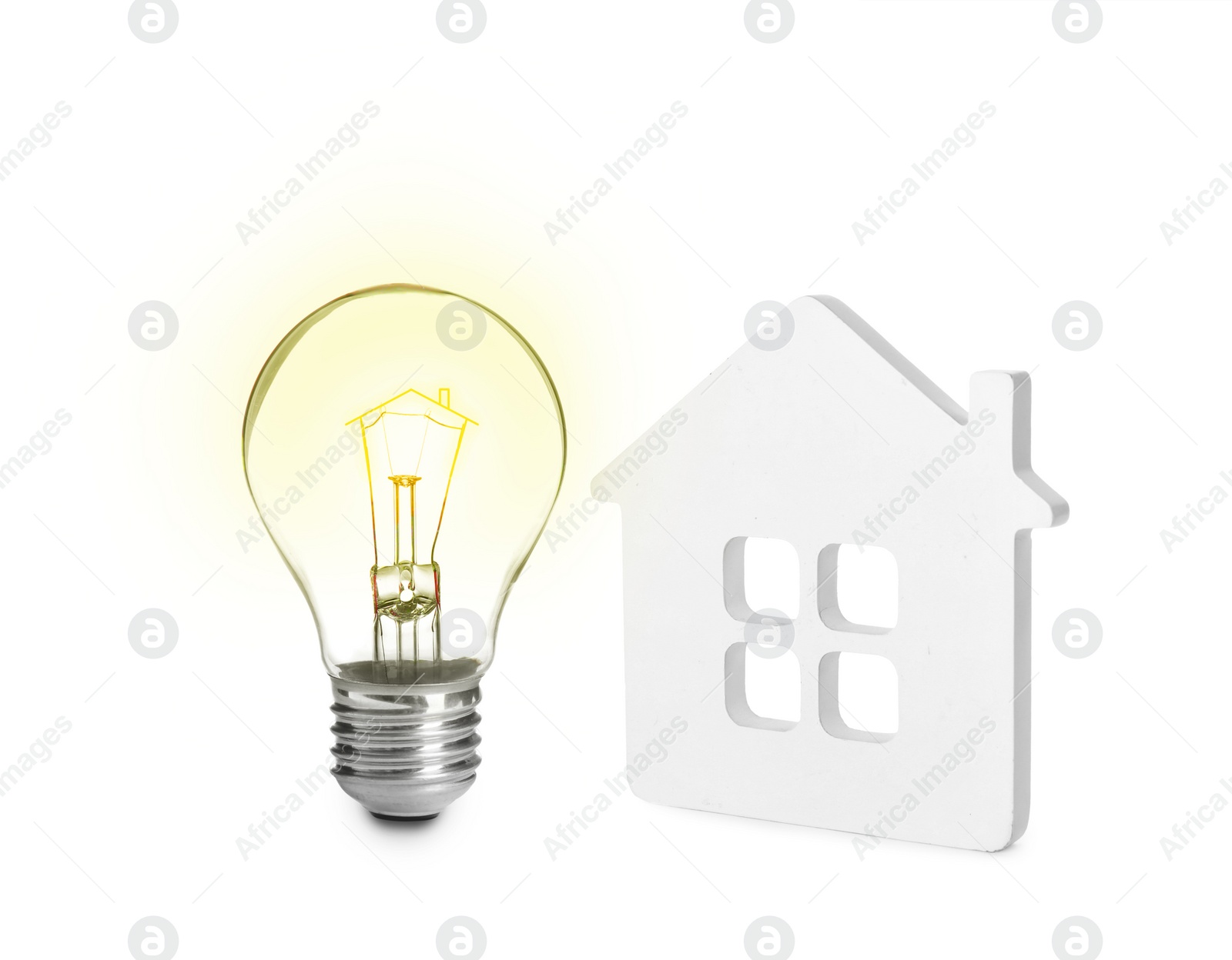 Image of Glowing light bulb and small model of house on white background. Energy efficiency, loan, property or business idea concepts