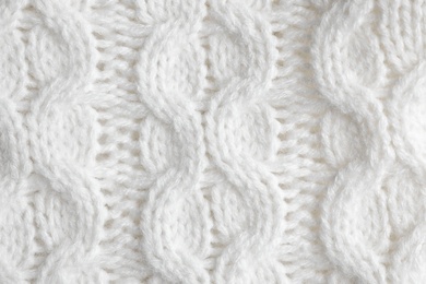 White knitted sweater as background, closeup view