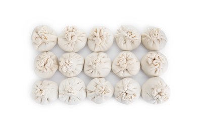 Photo of Many uncooked khinkali (dumplings) isolated on white, top view. Georgian cuisine