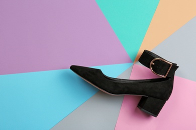 Female shoe on color background, top view