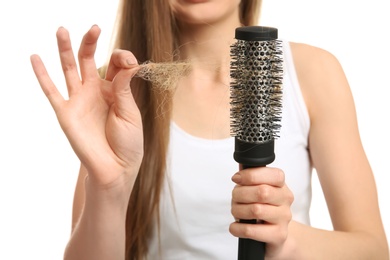 Young woman with hair loss problem on white background