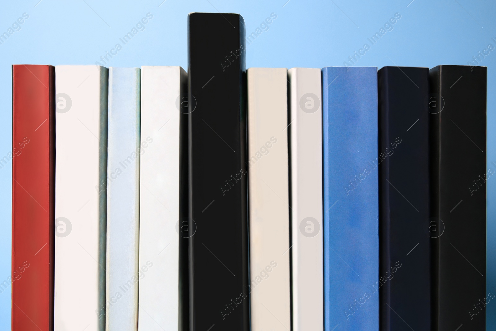 Photo of Collection of books on light blue background