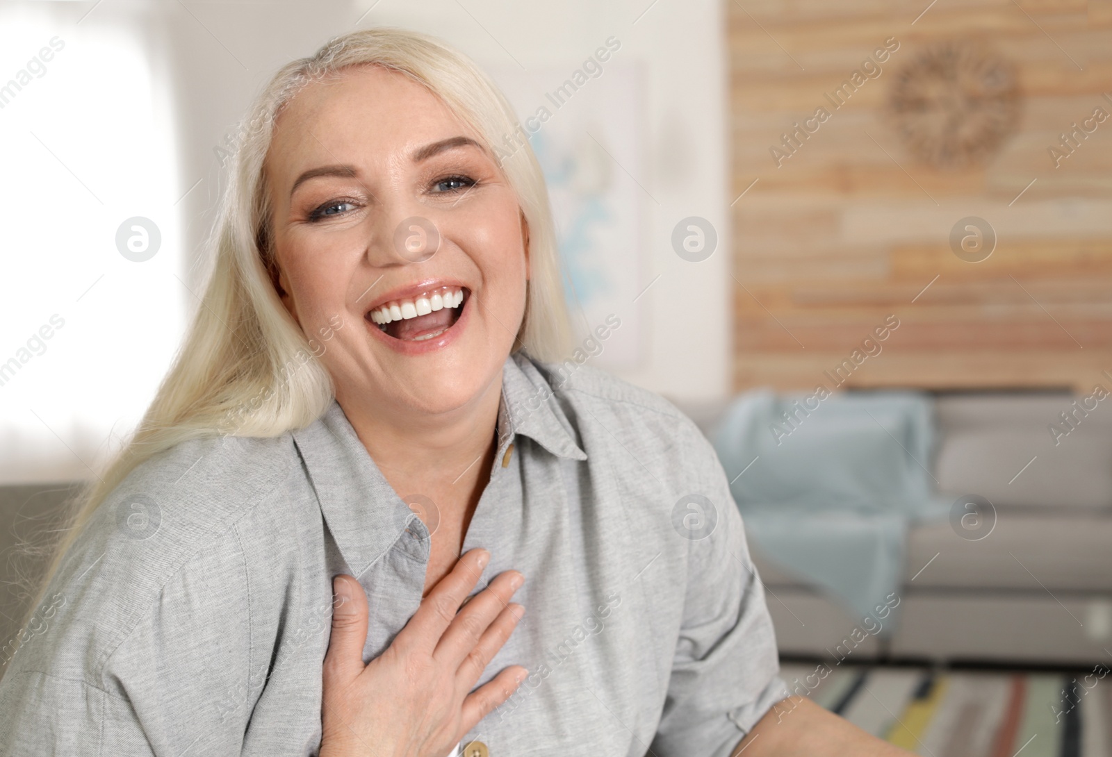 Photo of Portrait of mature woman in living room