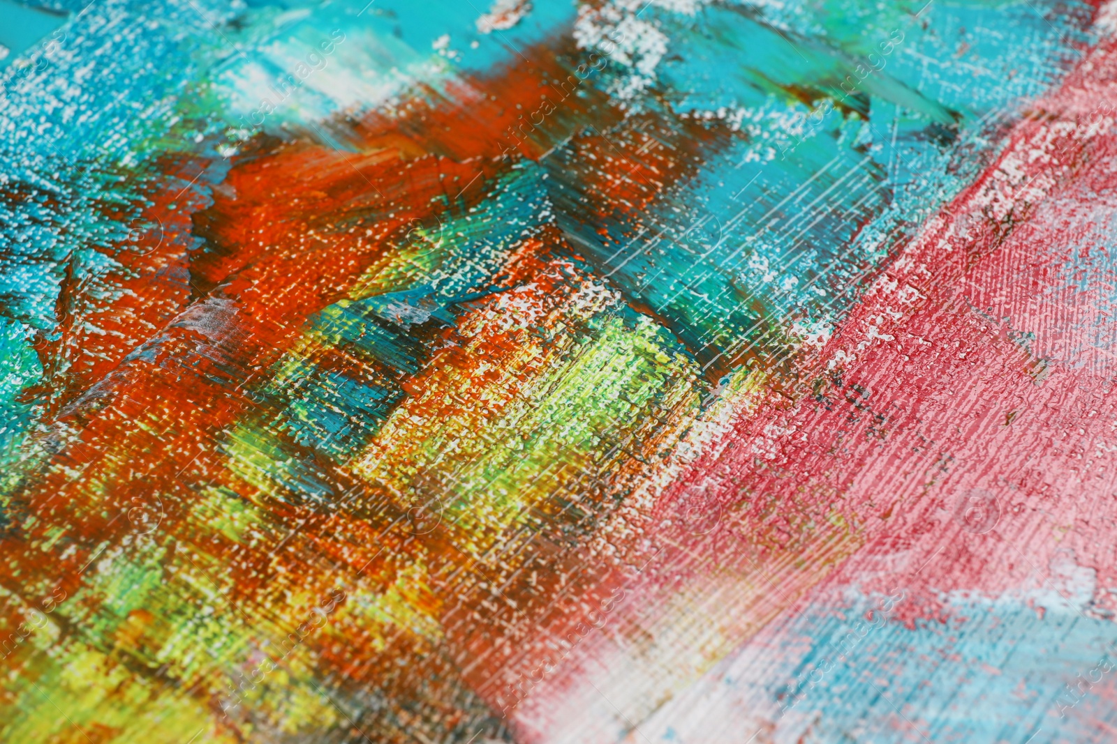 Photo of Strokes of colorful acrylic paints on canvas, closeup