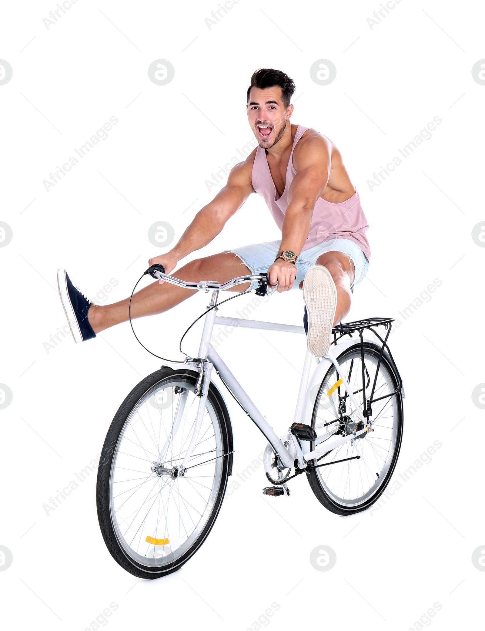 Photo of Handsome young hipster man riding bicycle on white background