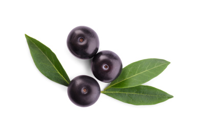 Fresh acai berries with leaves isolated on white, top view