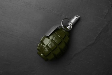 Photo of Hand grenade on black background, top view