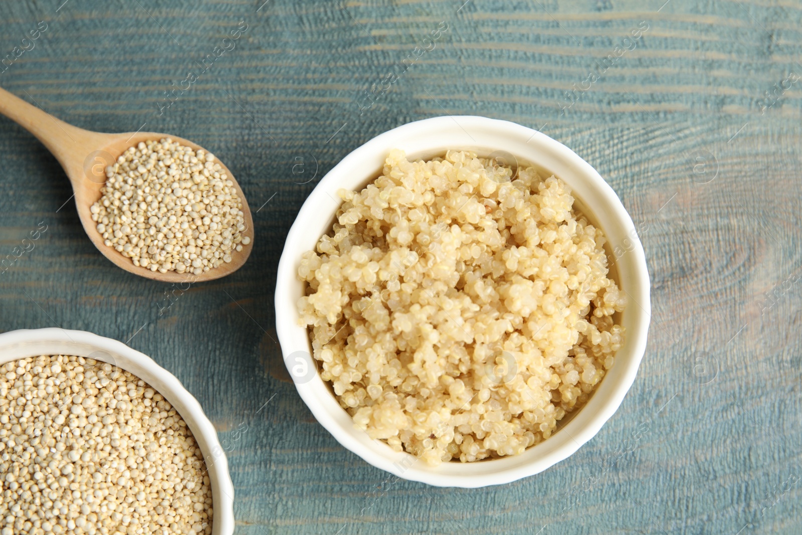 Photo of Flat lay composition with raw and cooked quinoa on table