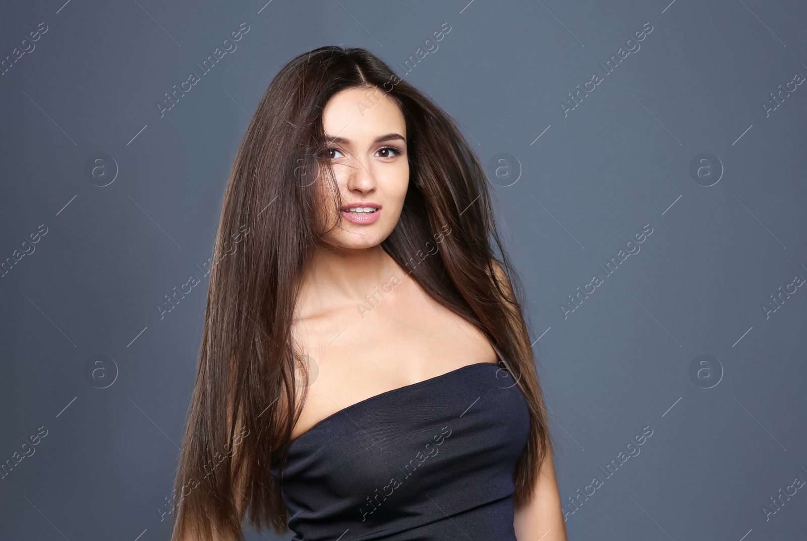 Photo of Portrait of beautiful model with gorgeous straight hair on color background