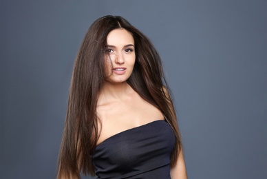 Photo of Portrait of beautiful model with gorgeous straight hair on color background