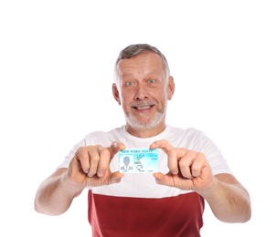 Happy mature man with driving license on white background