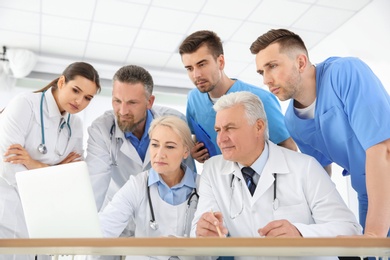 Photo of Group of doctors attending meeting in clinic. Cardiology conference