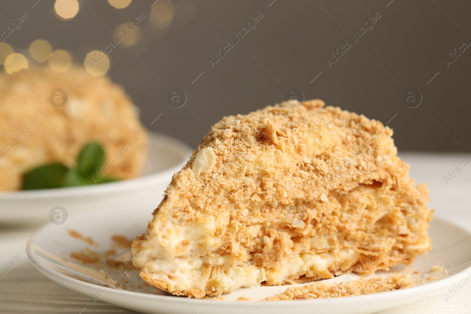 Photo of Piece of delicious Napoleon cake on table, closeup