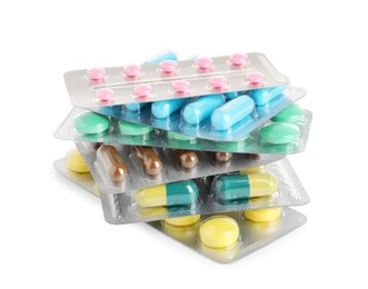 Stack of blisters with different pills on white background