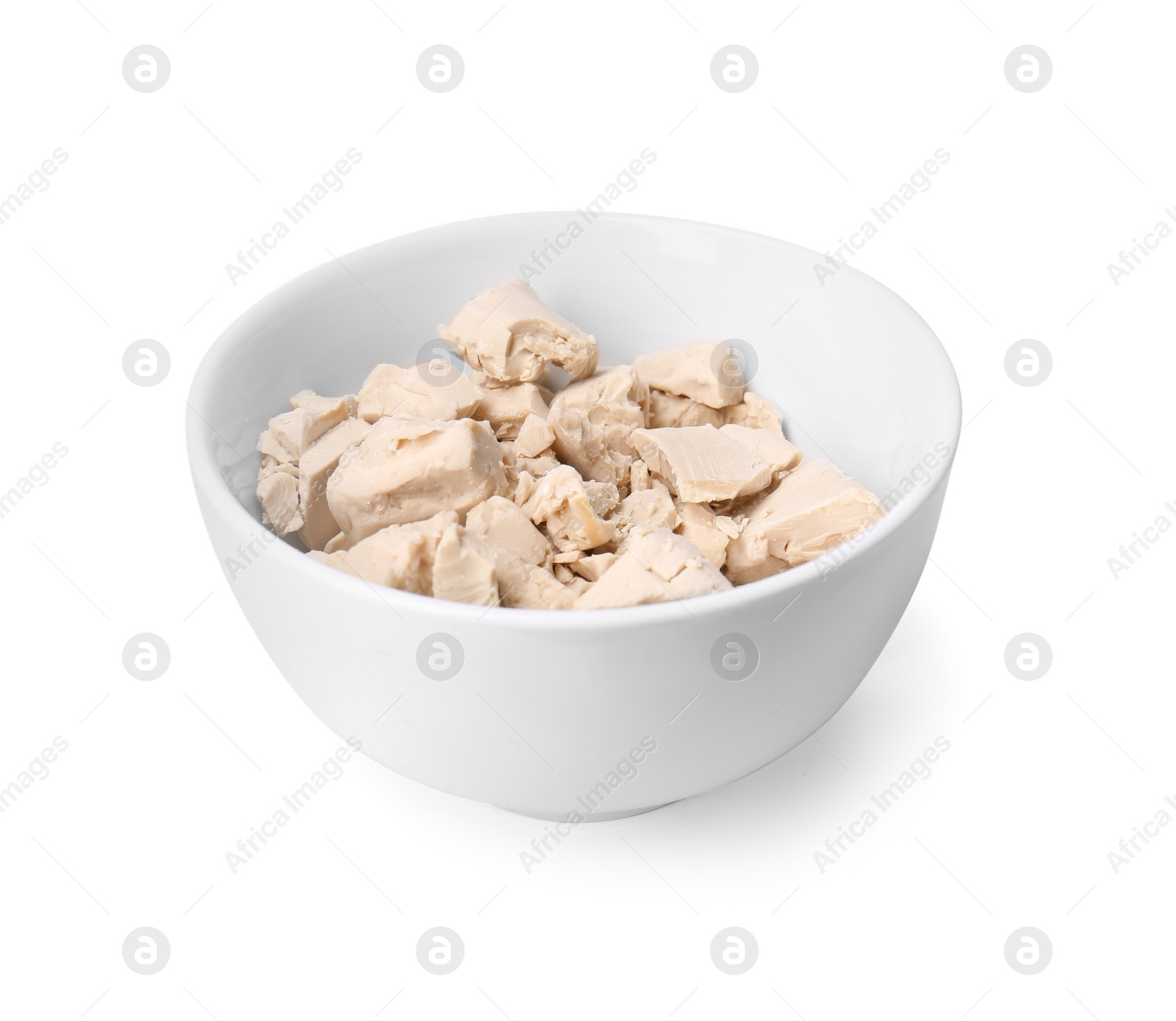 Photo of Pieces of compressed yeast in bowl isolated on white