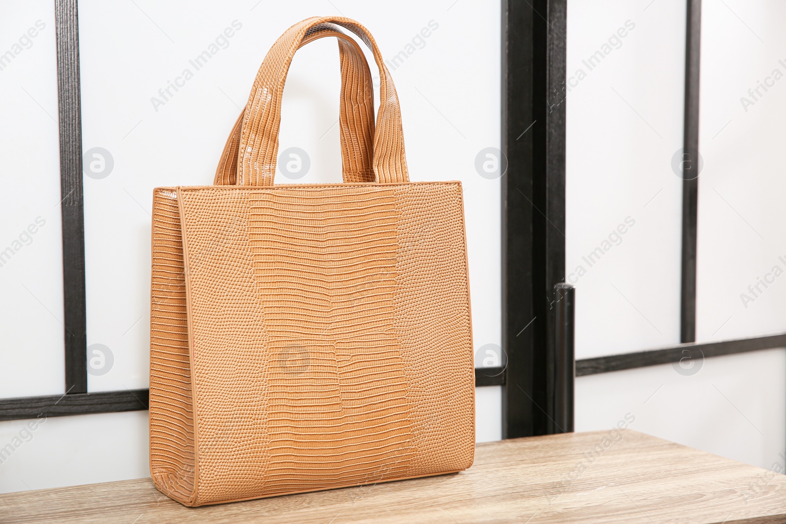 Photo of Leather woman's bag on wooden shelf in store