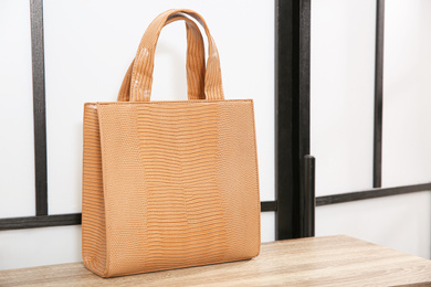 Photo of Leather woman's bag on wooden shelf in store