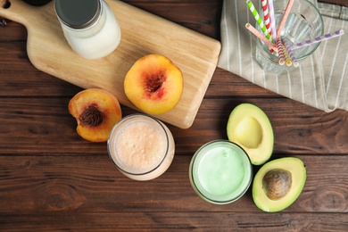 Photo of Flat lay composition with delicious milk shakes on wooden background