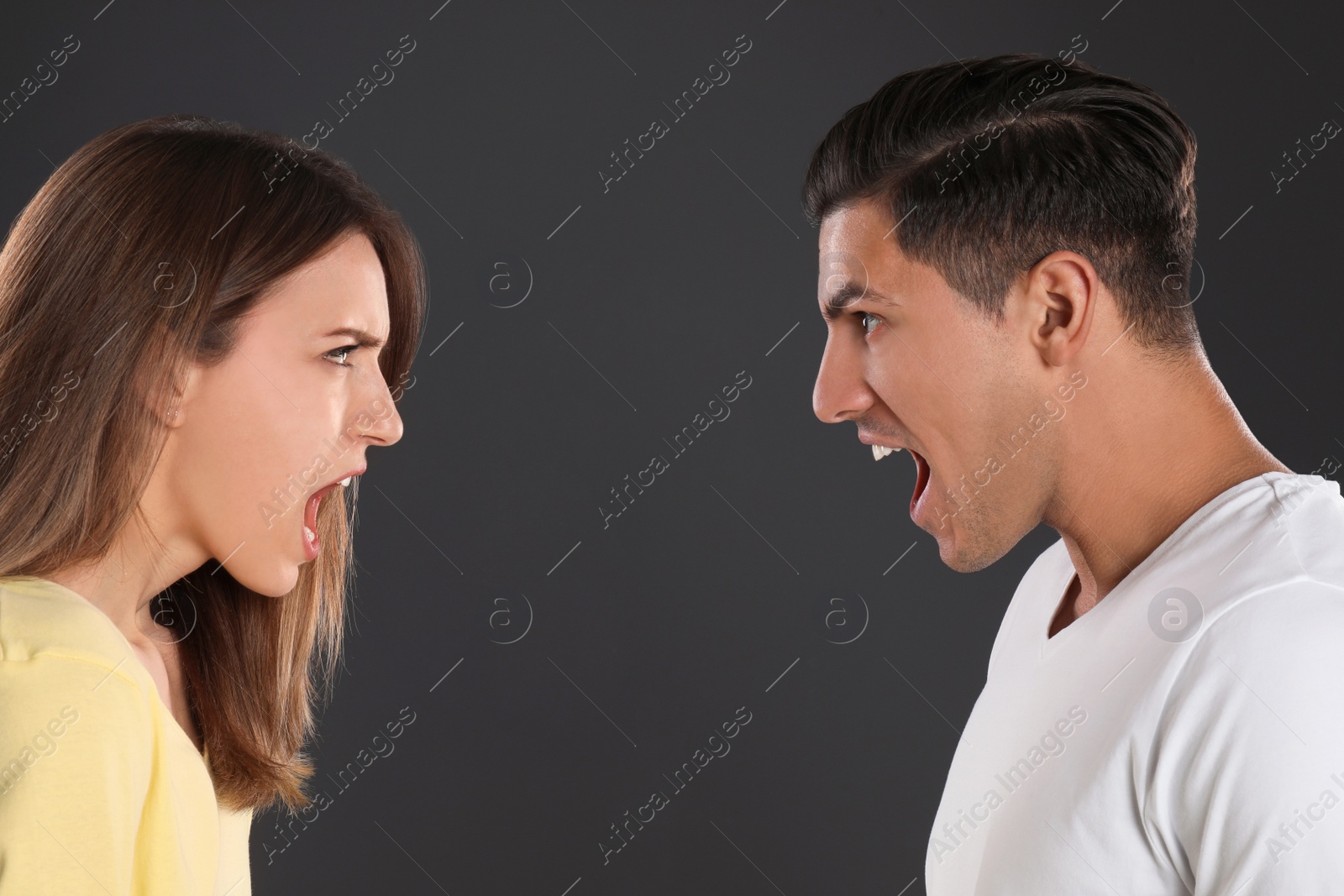 Photo of Couple quarreling on black background. Relationship problems