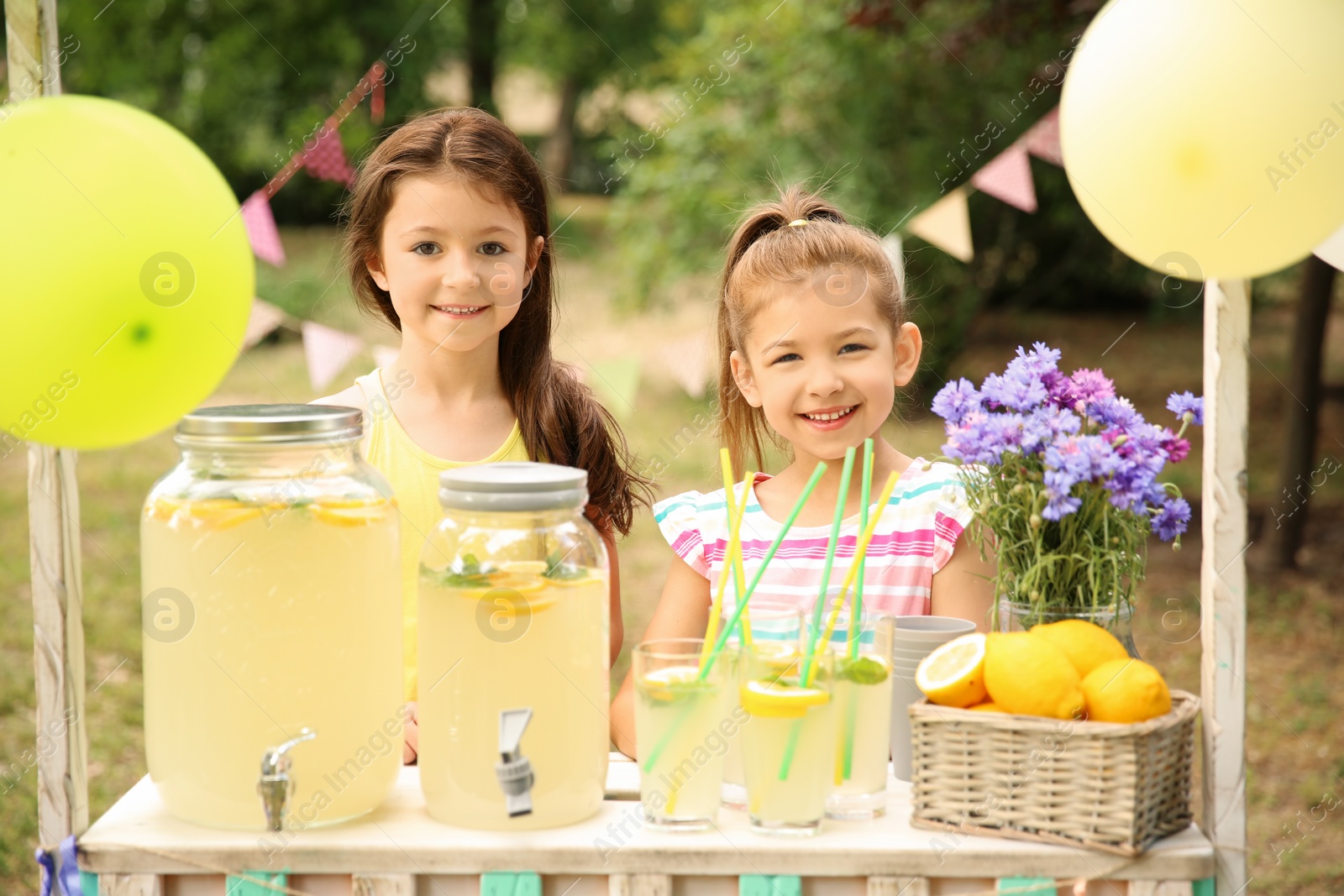 Photo of Little girls at lemonade stand in park