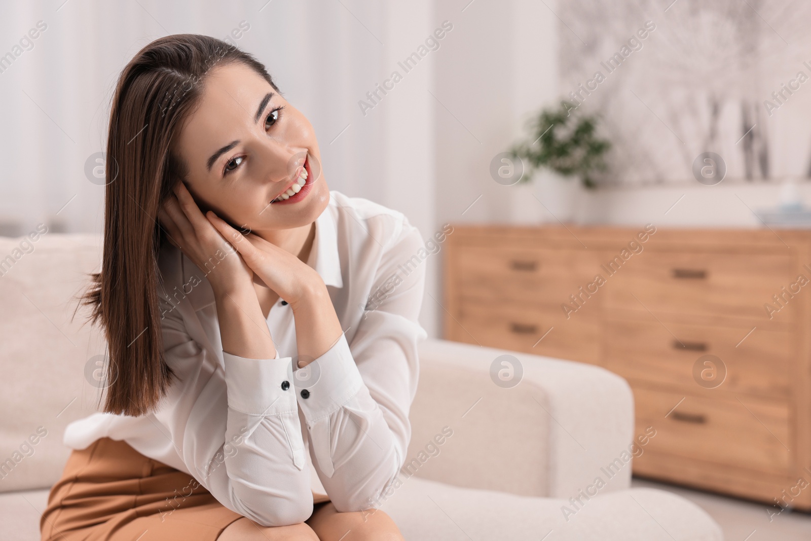 Photo of Portrait of beautiful woman smiling in room, space for text