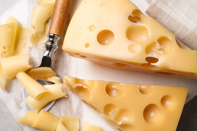 Tasty fresh cheese on white marble board, flat lay