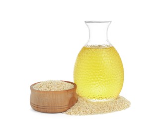 Photo of Glass bottle of fresh sesame oil and bowl with seeds isolated on white