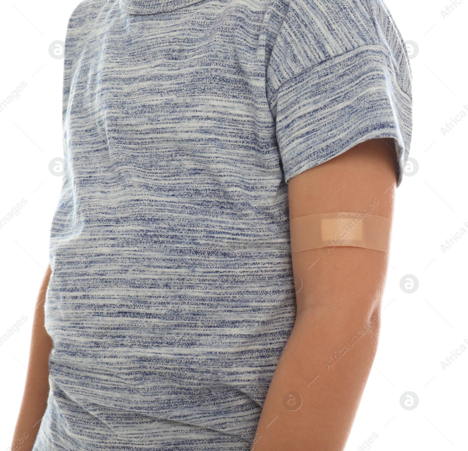 Photo of Little boy with sticking plaster on arm against white background, closeup