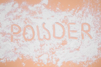 Photo of Word Powder made of baby cosmetic product on pale coral background, top view