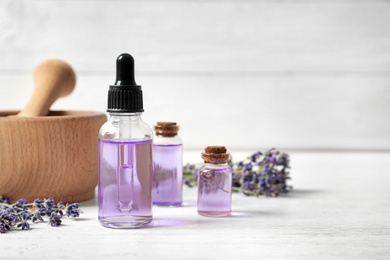 Photo of Composition with natural cosmetic products and lavender flowers on white wooden table