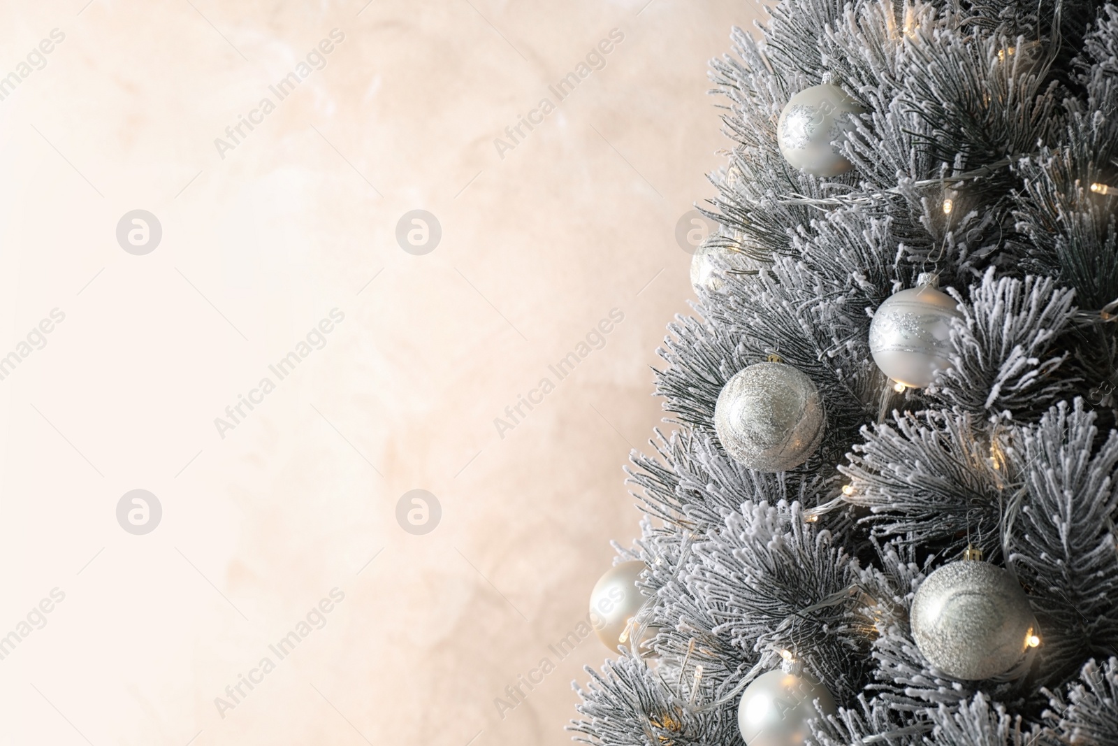 Photo of Beautiful Christmas tree with decor on light background. Space for text