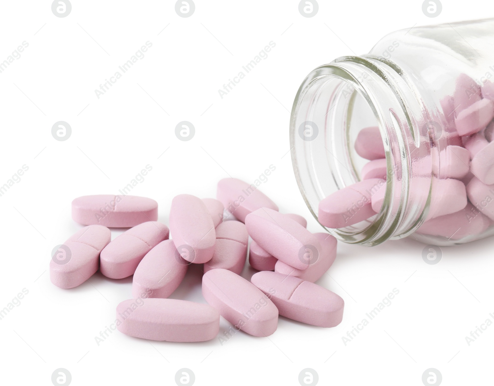 Photo of Scattered vitamin pills and bottle isolated on white