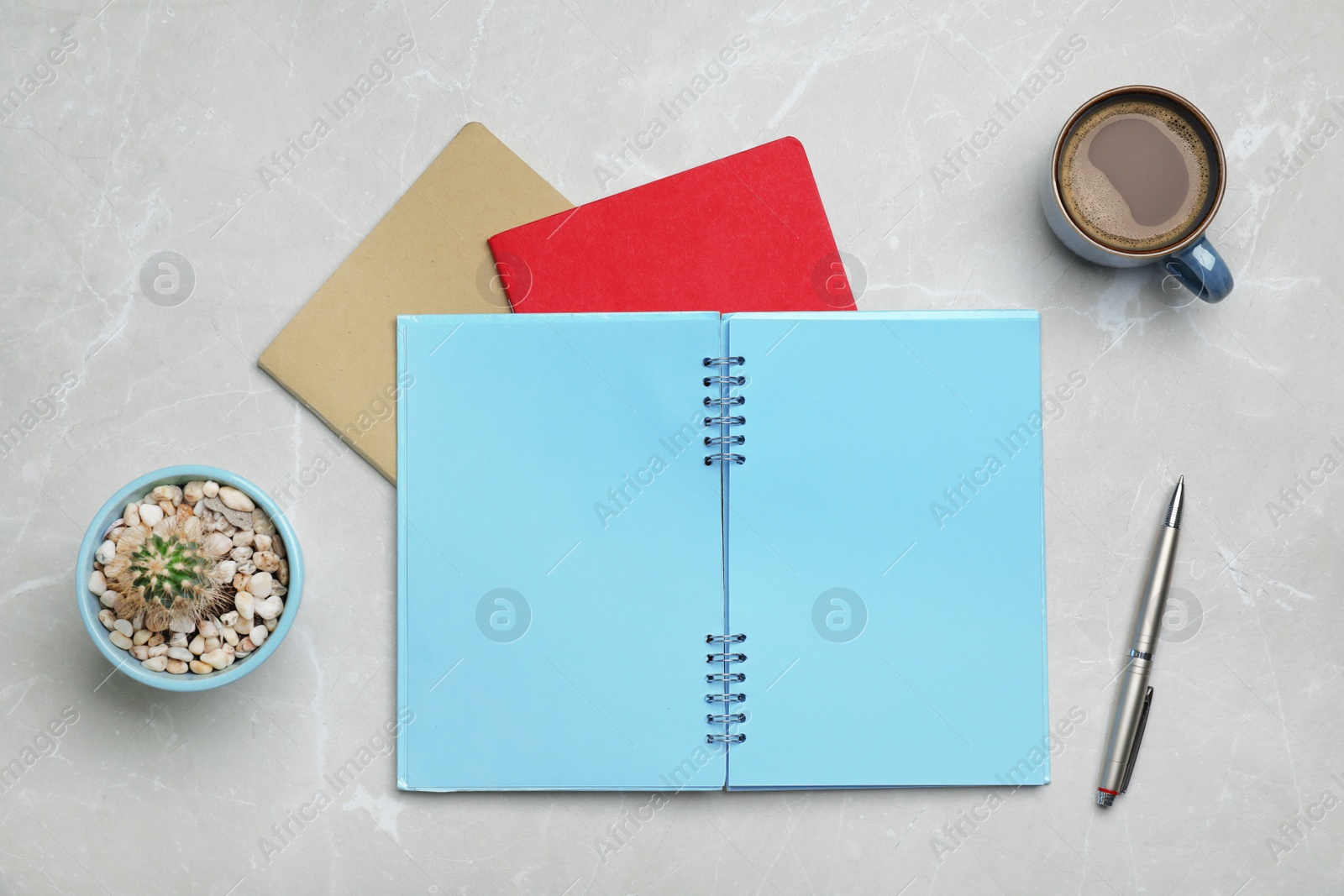 Photo of Flat lay composition with notebooks and cup of coffee on grey background