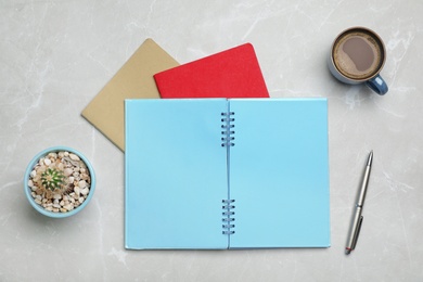 Photo of Flat lay composition with notebooks and cup of coffee on grey background