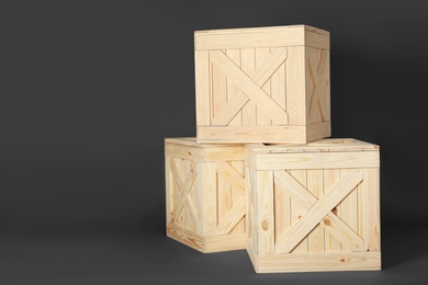 Wooden crates on dark background, space for text. Shipping containers