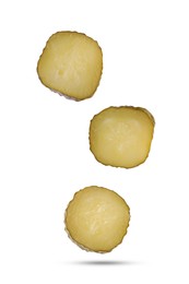 Image of Slices of tasty pickled cucumbers falling on white background