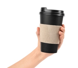 Photo of Woman holding takeaway paper coffee cup with cardboard sleeve on white background, closeup