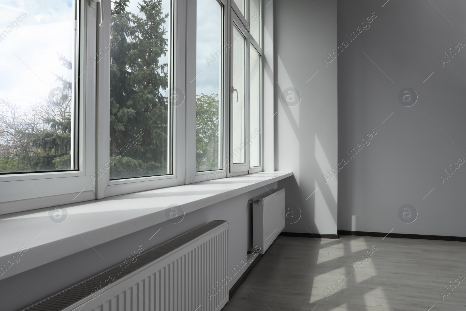 Photo of Modern office with window and radiators. Interior design