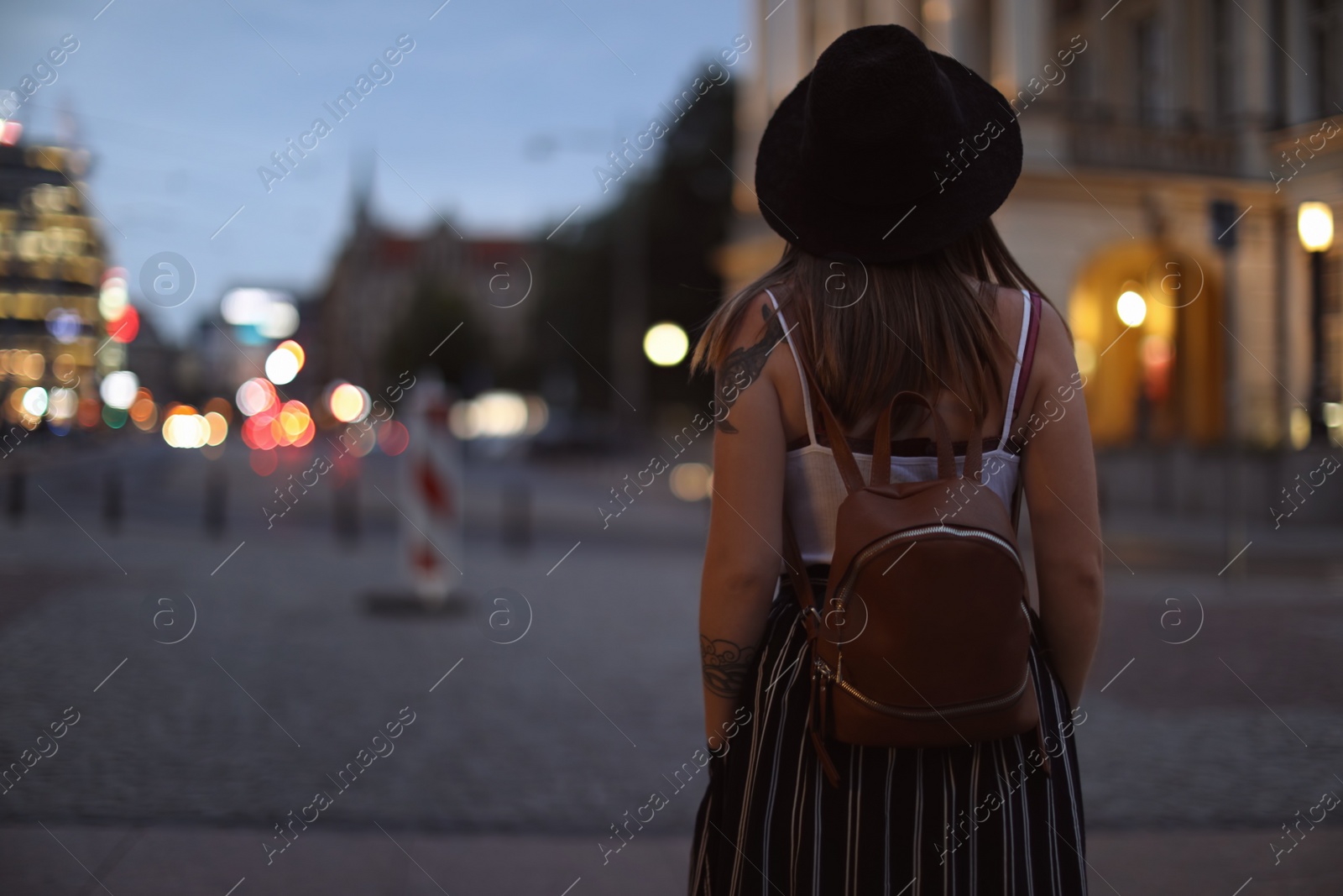 Photo of Young woman in stylish outfit on city street